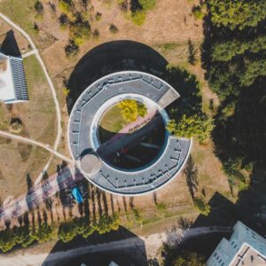 Drone photo capturing a circular building in Bordeaux, France, with greenery surrounding.